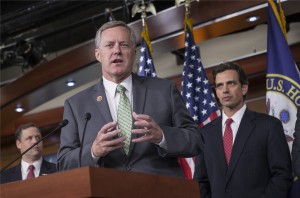 Rep. Mark Meadows, R-N.C, center, Rep. Tom Graves, R-Ga., right, and other conservative Republicans discuss their goal of obstructing the Affordable Care Act, popularly known as Obamacare, as part of a strategy to pass legislation to fund the government, on Capitol Hill in Washington, Thursday, Sept. 19, 2013. [CREDIT: J. Scott Applewhite, for The Associated Press]
