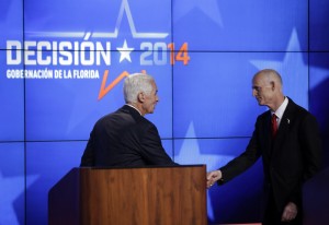 Charlie Crist, left, shakes hands with Gov. Rick Scott after a gubernatorial debate at the Spanish-language network Telemundo 51, Friday, Oct. 10, 2014, in Miramar, Fla. This is the first of three debates before the November election. (AP Photo / Lynne Sladky)